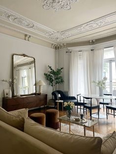 a living room filled with furniture and a large mirror