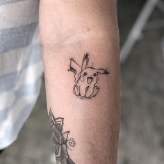 a tattoo on the arm of a man with a rabbit in it's head