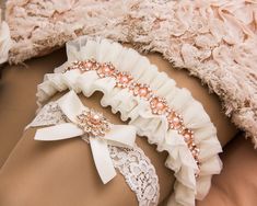 "Rose Gold Wedding Garter Set Rose Gold Bridal Garter Wedding Garter Set Tulle Bridal Garter Set Bridal Garter Belt Bridal Shower gift This stunning Bridal garter Set is made with off white tulle 2 1/4\" large and fine ivory lace with floral motif. KEEPSAKE garter is decorated with a rose gold rhinestone and pearl trim. TOSS garter is made with ivory stretch lace and a rose gold rhinestone and pearl jewel. Keepsake garter can be purchase separately or as a set with the tossing garter. Please kee Garter Wedding, Bridal Garters Set, Wedding Garter Set, Pearl Jewels, Rose Gold Bridal, Bridal Garter, Wedding Garter, Garter Set, White Tulle