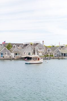 a boat floating on top of a lake next to houses