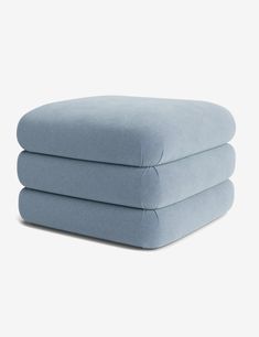 three blue pillows stacked on top of each other