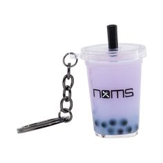 a purple drink with black dots on it and a metal keychain attached to it