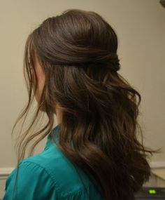 a woman with long brown hair in a ponytail