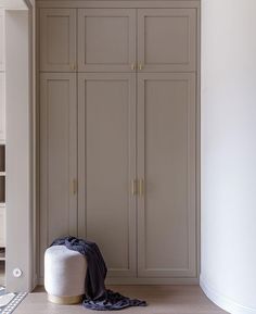 an empty room with two large closets and a rug on the floor in front of it