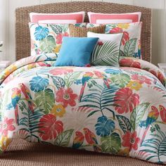 a bed with colorful flowers and leaves on it