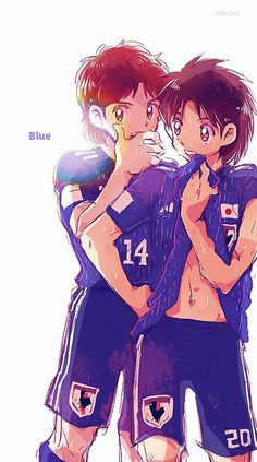 two young men hugging each other while wearing soccer uniforms