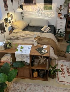 a bed room with a neatly made bed and lots of pictures on the wall above it