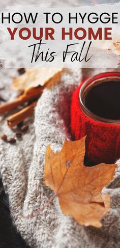 a cup of coffee and autumn leaves on a blanket with text overlay how to hygge your home this fall