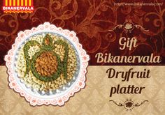 a plate with nuts on it and the words gift bikanevada dryfruit platter