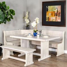 a white table and benches in a room