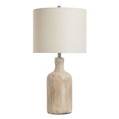 a table lamp with a white shade on the base and a light bulb attached to it