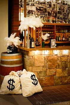 two bags sitting on the floor in front of a bar with liquor bottles and money signs