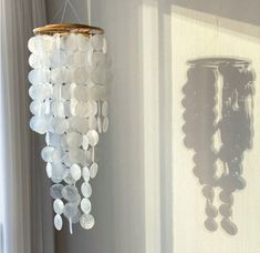 a chandelier hanging from the side of a wall in front of a window