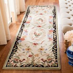 a white rug with flowers on it in a living room