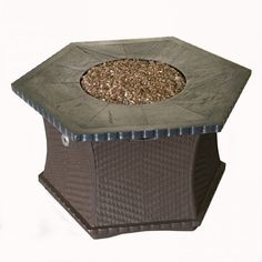 an outdoor fire pit with gravel in the center and metal grate around it's edges