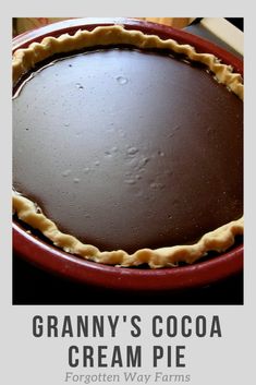 a chocolate cream pie sitting on top of a red plate with the words granny's cocoa cream pie