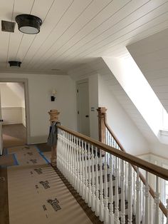 an empty room with white railings and blue tape on the floor next to it