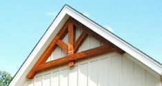 a white house with a wooden roof and windows