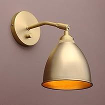 a white wall mounted light on a purple wall