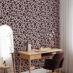 an animal print wallpaper in the corner of a room with a desk and chair