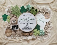 a baby's birth announcement with teddy bears and other items on a white blanket