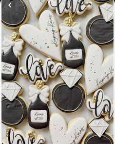 decorated cookies are arranged in the shape of hearts and envelopes with love written on them