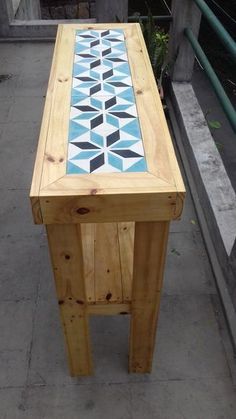 a wooden bench sitting on top of a sidewalk