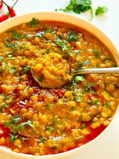 a white bowl filled with food and garnished with cilantro