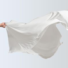 a person holding a white cloth in the air