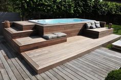 a hot tub sitting on top of a wooden deck