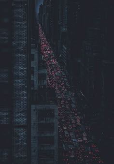 a city street filled with lots of traffic under a cloudy sky at night in the dark