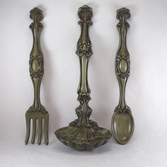 three antique spoons and two forks on a white background