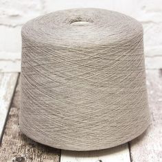 a skein of yarn sitting on top of a wooden floor