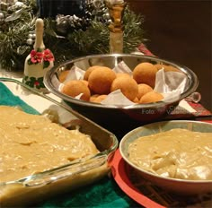 two bowls filled with food sitting on top of a table next to other dishes and decorations