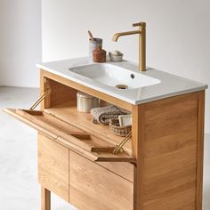 a bathroom sink sitting on top of a wooden cabinet