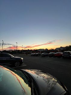 cars parked in a parking lot at sunset