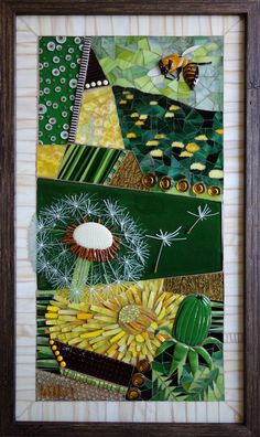 an art work with green, yellow and white items in a wooden frame on the wall