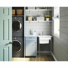 a washer and dryer in a small room next to a door with open shelves