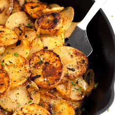 a skillet filled with cooked potatoes and garnished with parsley