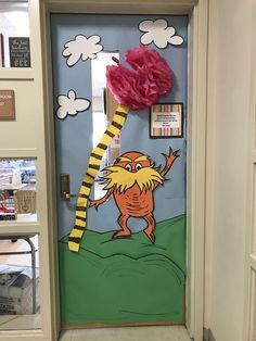 a door decorated with an image of a cat in the hat holding a pink pom - pom