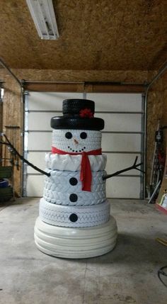 a snowman made out of tires is shown in the middle of an instagramtion