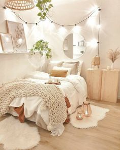 a bedroom with white walls and lights around the bed, rugs on the floor