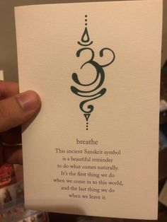 someone is holding up a card with the words breathe on it and an ornamental design