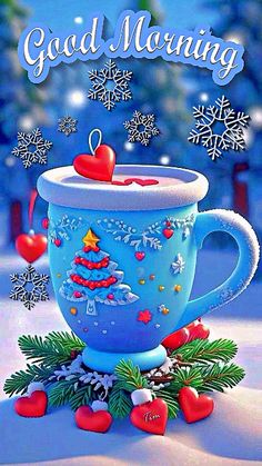 a blue coffee cup sitting on top of a snow covered ground next to christmas decorations