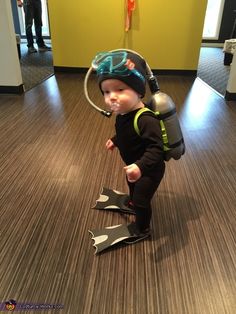 a young boy wearing a diving suit and helmet