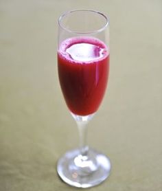 a glass filled with liquid sitting on top of a table