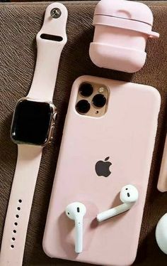 an apple watch, headphones and earbuds are laying next to each other