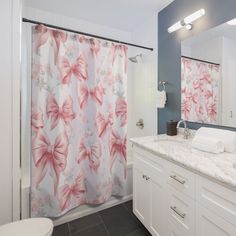 a bathroom with blue walls, white cabinets and a pink shower curtain in the corner