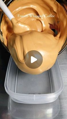 a bowl filled with peanut butter on top of a metal counter