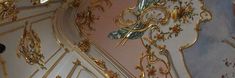 an ornately decorated ceiling with gold and blue paint on the walls in a room